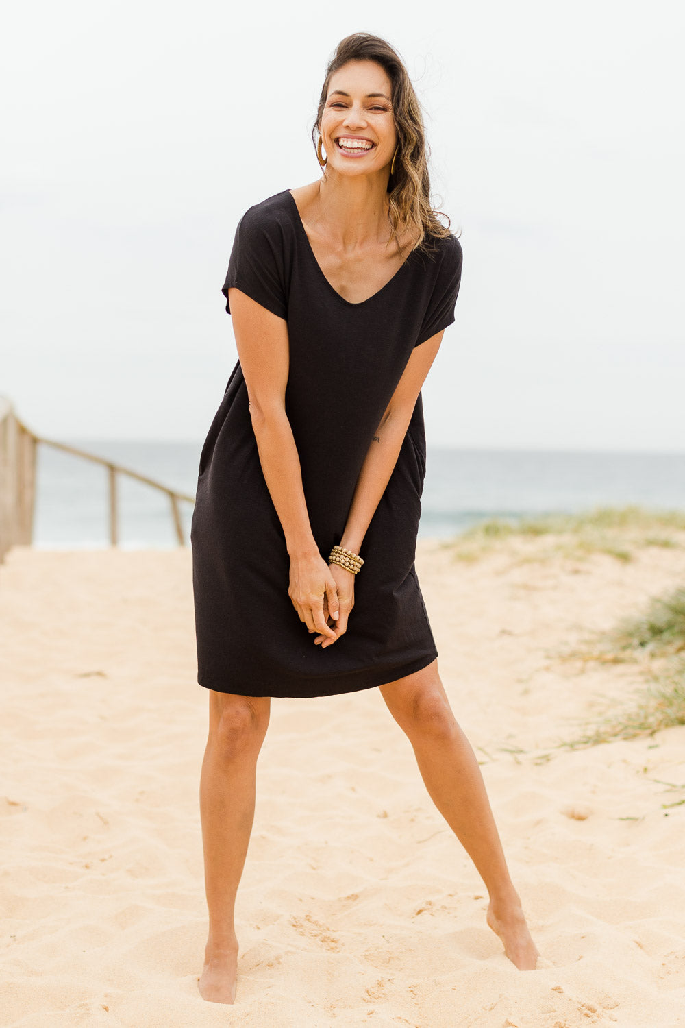 Model Amanda wearing size S of The Relaxed Jersey Dress in colour Black (Black), from the front, showing the whole outfit