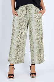 Model Pamela wearing size 10 of The Print Pull On Pant in colour Khaki (Green), from the front, cropped image