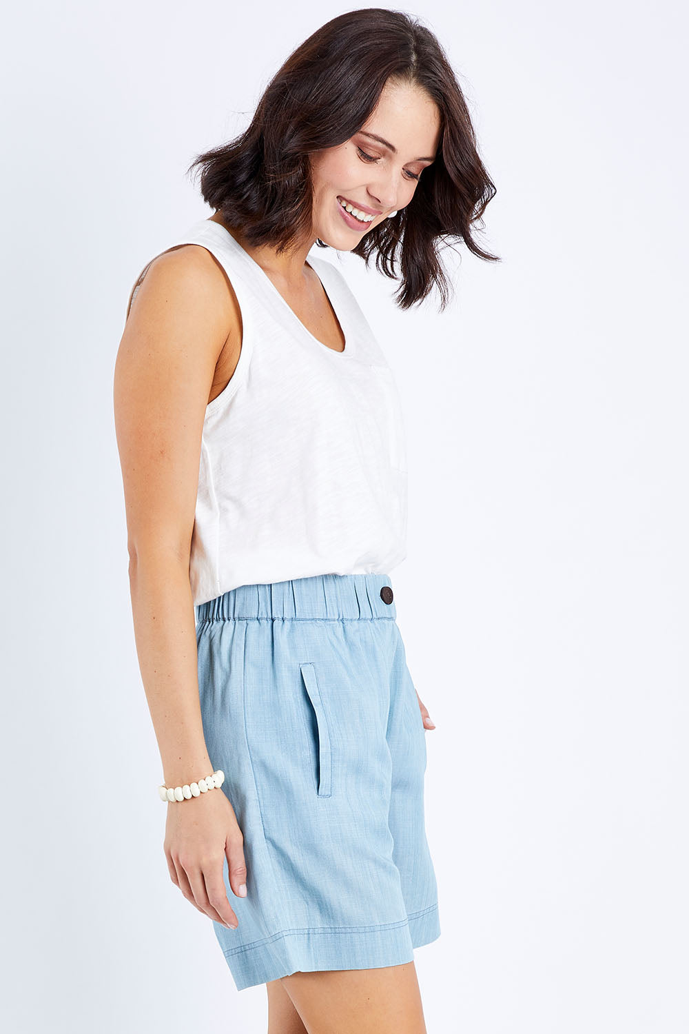 Model Andrea wearing size 10 of The Chambray Walk Short in colour Chambray (Blue), from the front, cropped image