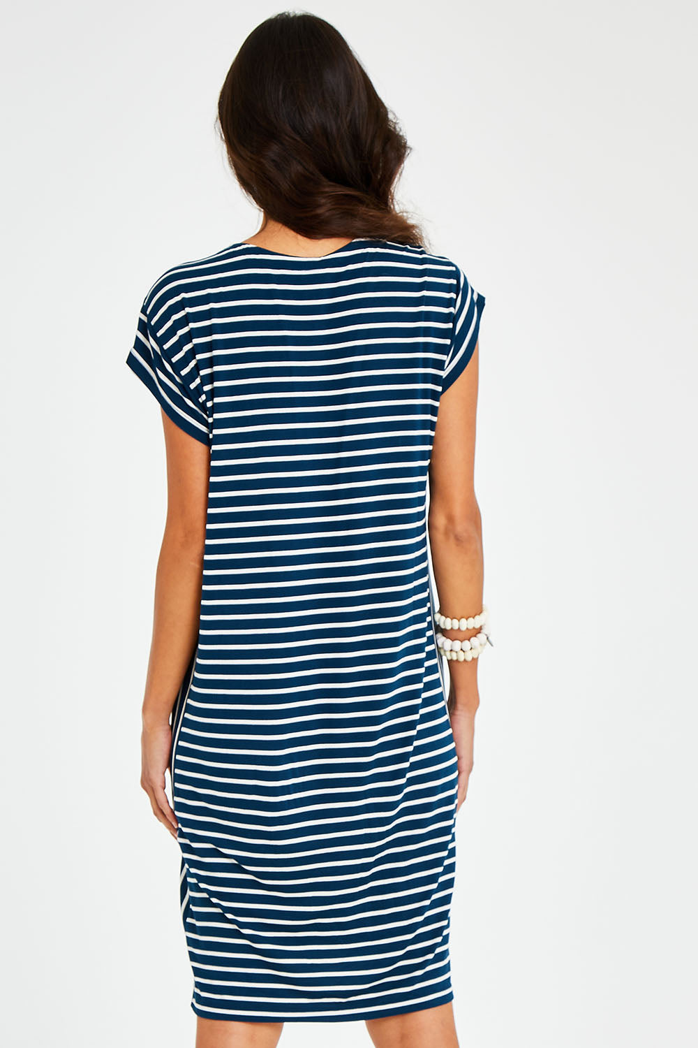Model Vitoria wearing size 10 of The Summer Stripe Dress in colour Inkpetrol (Blue), from the back