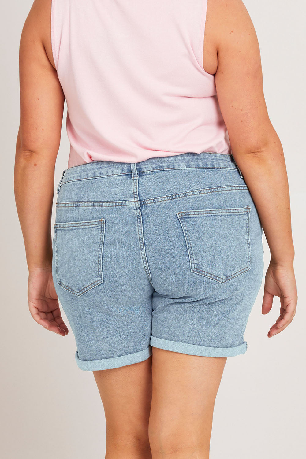 Model Poppys wearing size 16 of the The 5 Pocket Denim Short - Lightdenim in colour Lightdenim, from the back
