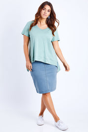 Model Laura wearing size 14 of The Pull On Denim Skirt in colour Lightdenim (Blue), from the front, showing the whole outfit