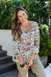 Model Amanda wearing size 10 of The V Neck Printed Top in colour Peachprint (White), from the front, showing the whole outfit