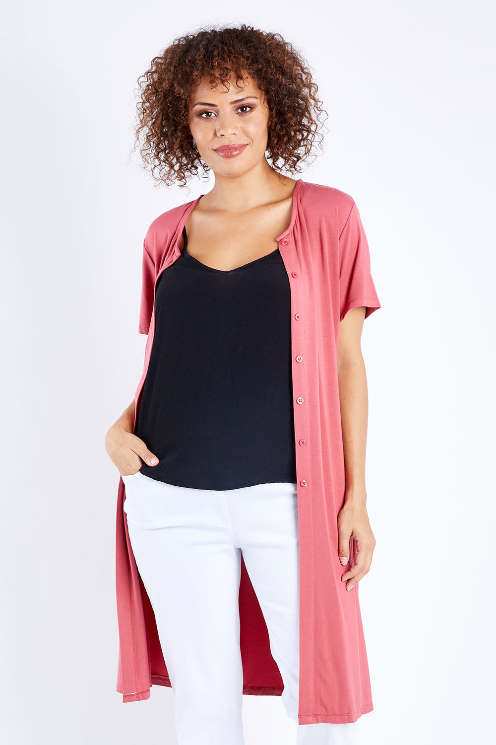 Model Lala wearing size 10 of The Short Sleeve Long Cardi in colour Desertrose (Pink), from the front, cropped image