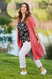 Model Laura wearing size 14 of The Short Sleeve Long Cardi in colour Desertrose (Pink), from the front, showing the whole outfit