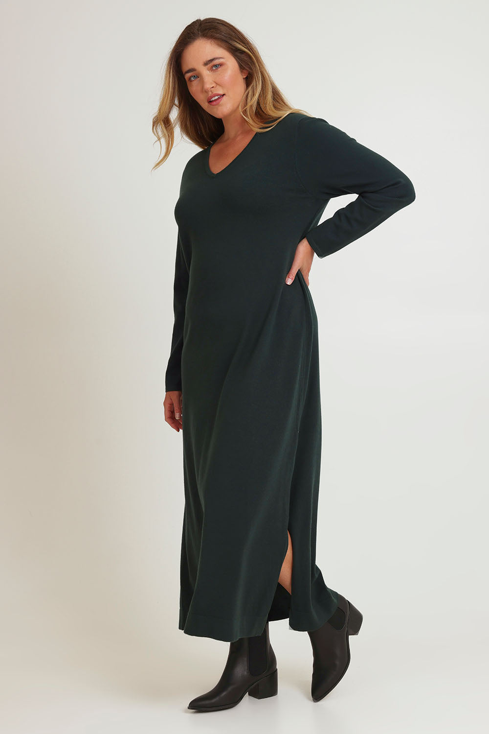 Model Caroline wearing size XL of The Comfort True Knit Dress in colour Darkpine (Green), from the front, showing the whole outfit