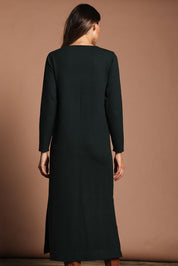 Model Madeline wearing size S of The Comfort True Knit Dress in colour Darkpine (Green), from the back
