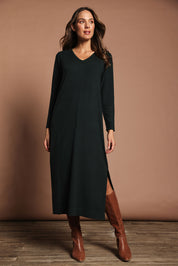 Model Madeline wearing size S of The Comfort True Knit Dress in colour Darkpine (Green), from the front, showing the whole outfit