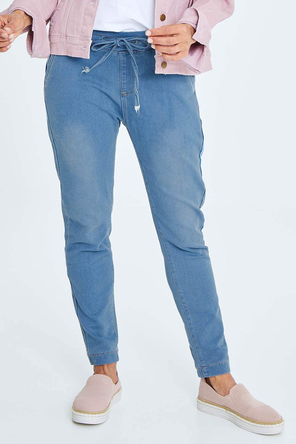 Model Cara wearing size 10 of The Weekend Pull On Jogger Jean in colour Denim (Blue), from the front, cropped image