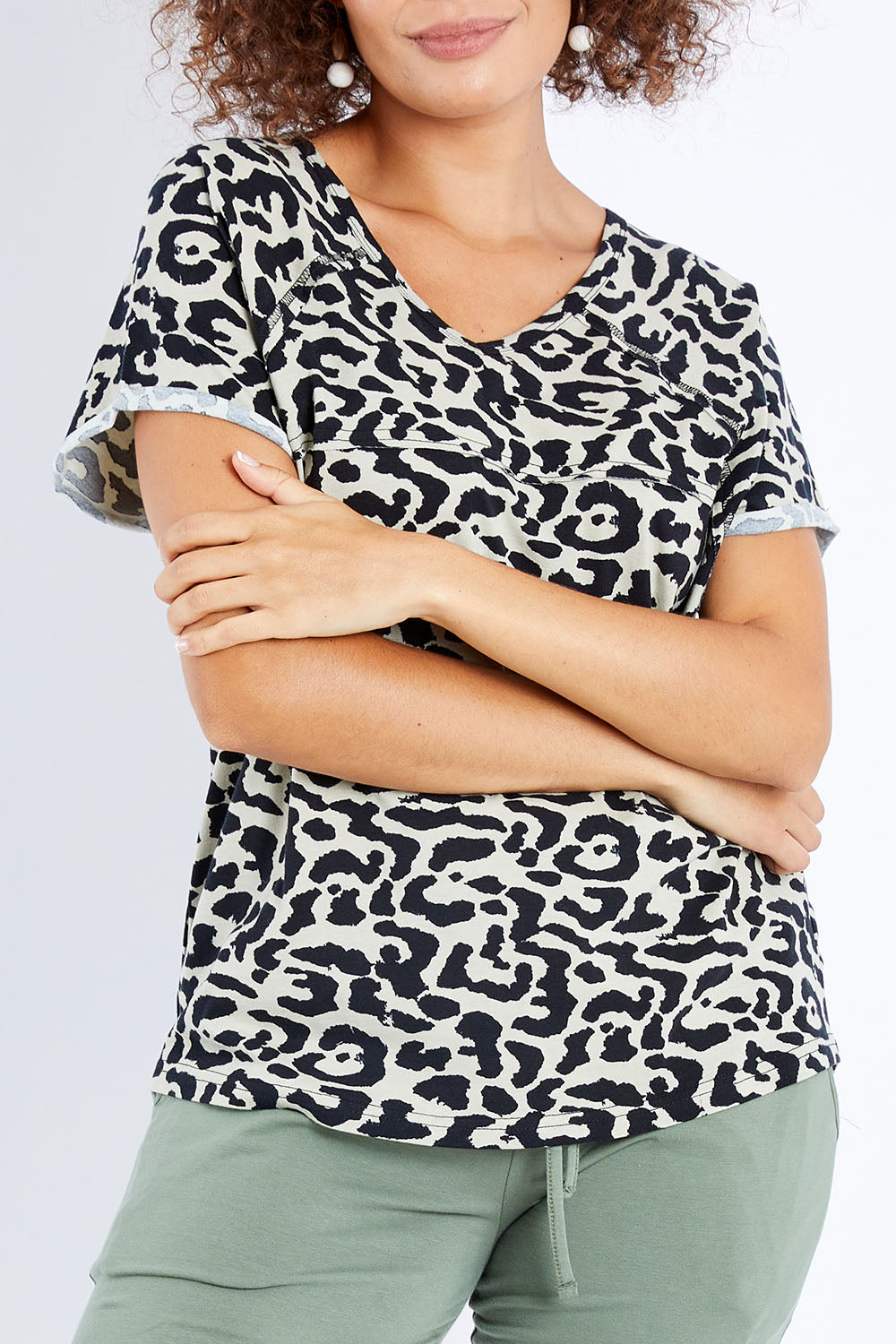 Model Lala wearing size 10 of The Slouch Tee in colour Animal (Green), from the front, cropped image
