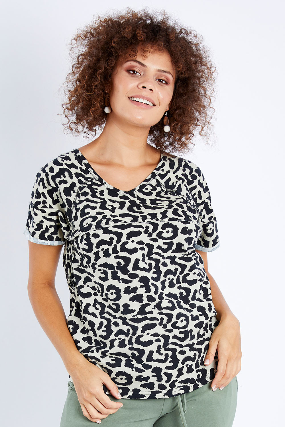 Model Lala wearing size 10 of The Slouch Tee in colour Animal (Green), from the front, cropped image