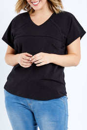 Model Jess wearing size 14 of The Slouch Tee in colour Black (Black), from the front, cropped image