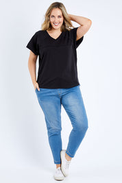 Model Jess wearing size 14 of The Slouch Tee in colour Black (Black), from the front, showing the whole outfit