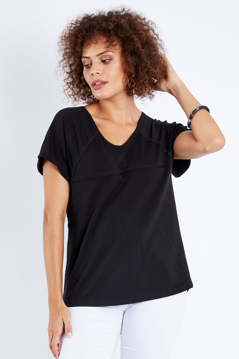 Model Lala wearing size 10 of The Slouch Tee in colour Black (Black), from the front, cropped image