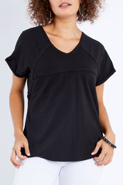 Model Lala wearing size 10 of The Slouch Tee in colour Black (Black), from the front, cropped image