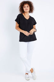 Model Lala wearing size 10 of The Slouch Tee in colour Black (Black), from the front, showing the whole outfit