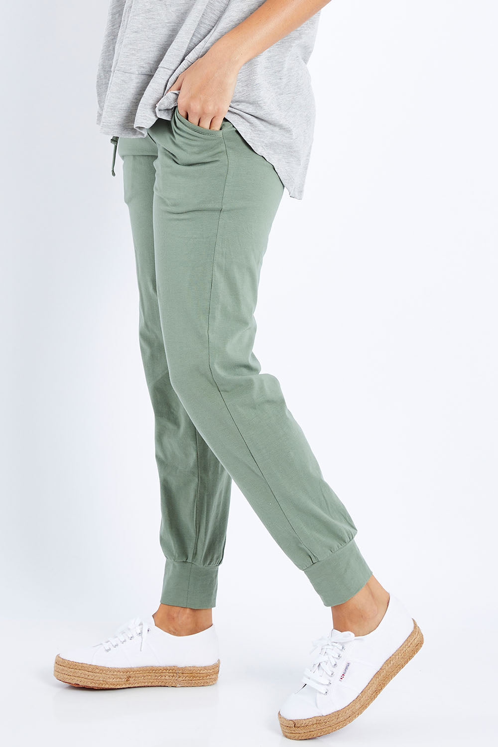 Model Lala wearing size 10 of The Everyday Pant in colour Khaki (Green), from the front, cropped image