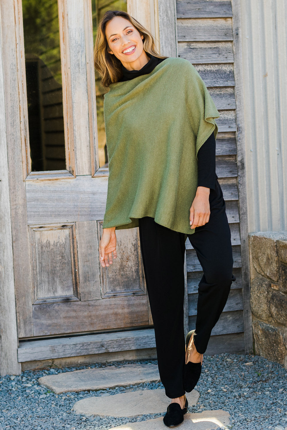 Model Amanda wearing size 10 of The Recycled Flat Front Pull On Pant in colour Black (Black), from the front, showing the whole outfit