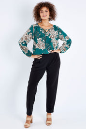 Model Lala wearing size 10 of The Recycled Flat Front Pull On Pant in colour Black (Black), from the front, showing the whole outfit