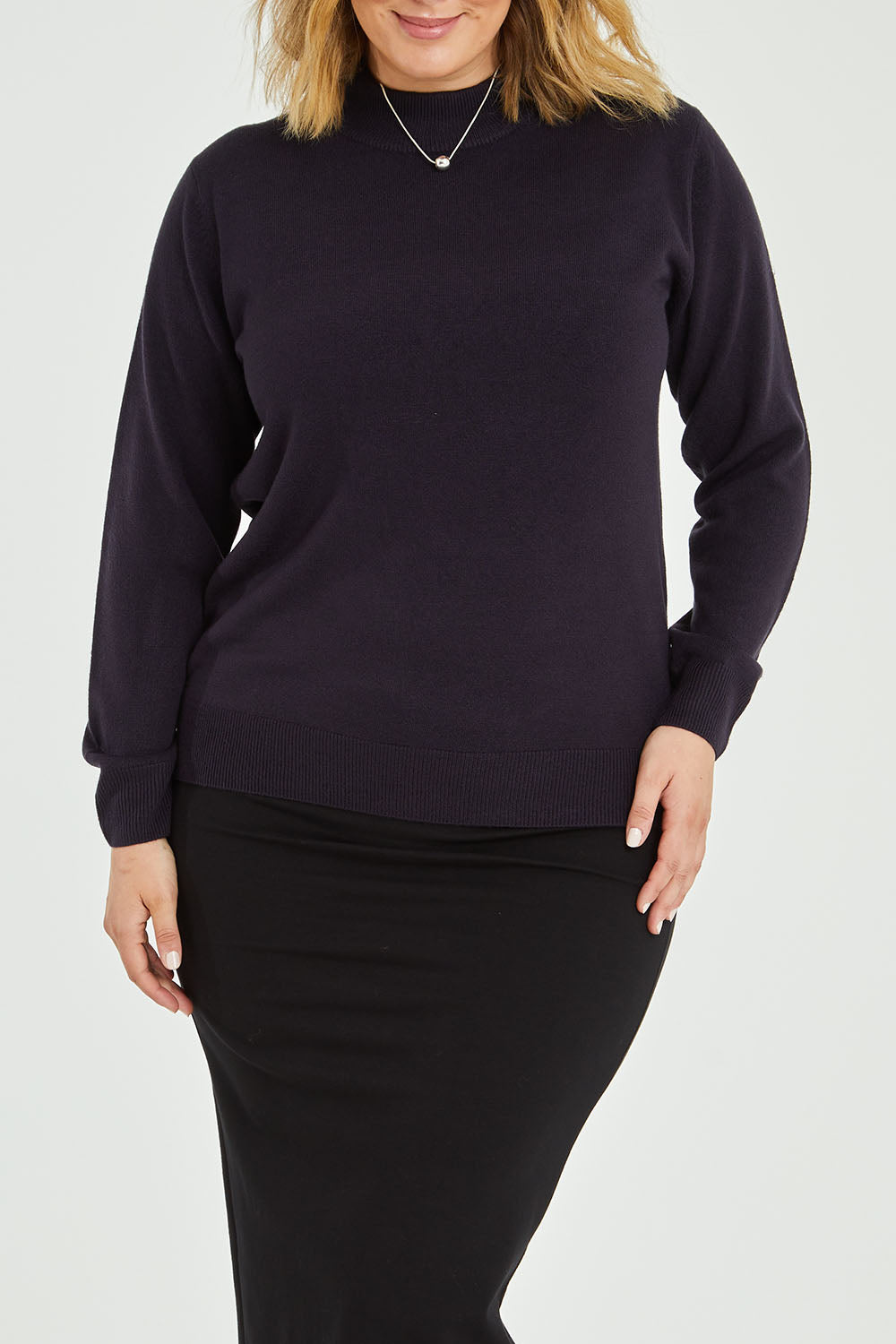 Model Jess wearing size L of The Essential Soft Jumper in colour Navy (Blue), from the front, cropped image