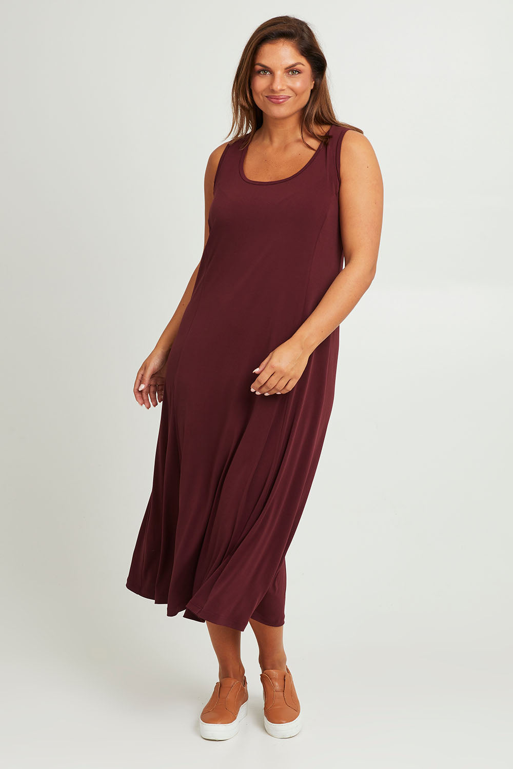 Model Monique wearing size 14 of The Recycled A Line Midi Dress in colour Burntplum (Purple), from the front, showing the whole outfit