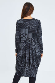 Model Cara wearing size 10 of The Jacquard Bounce Dress in colour Charcoal (Grey), from the back
