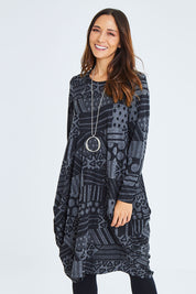 Model Cara wearing size 10 of The Jacquard Bounce Dress in colour Charcoal (Grey), from the front, cropped image