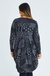 Model Palatina wearing size 16 of The Jacquard Bounce Dress in colour Charcoal (Grey), from the back