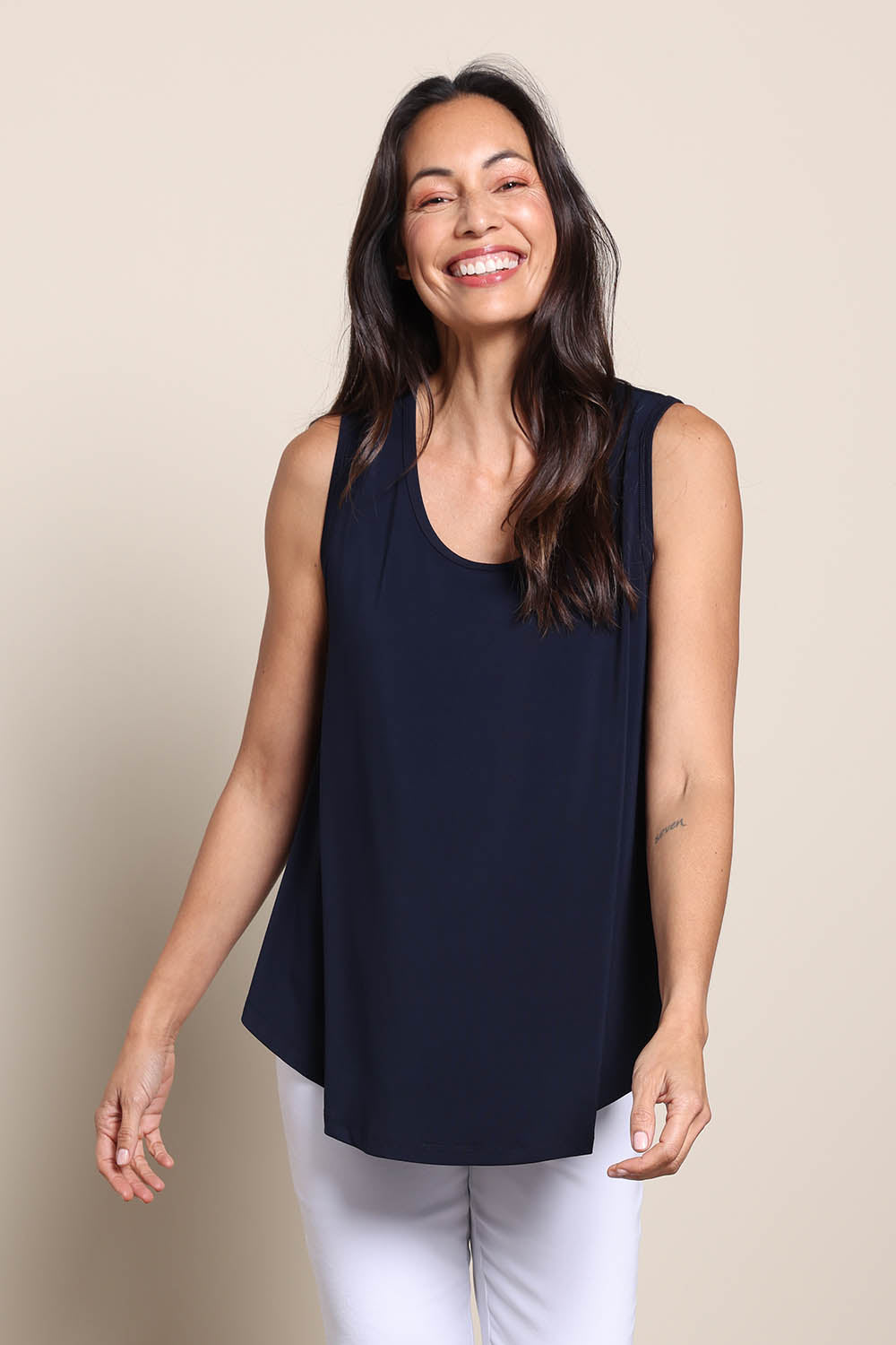 Model Amandam wearing size 10 of the The Essential Swing Tank – Navy in colour Navy, in a cropped view