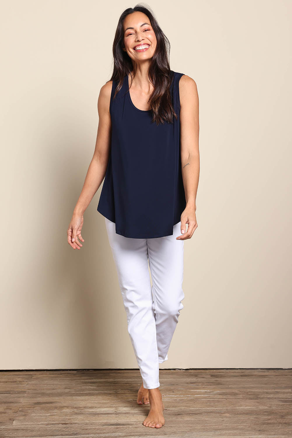 Model Amandam wearing size 10 of the The Essential Swing Tank – Navy in colour Navy, from the front