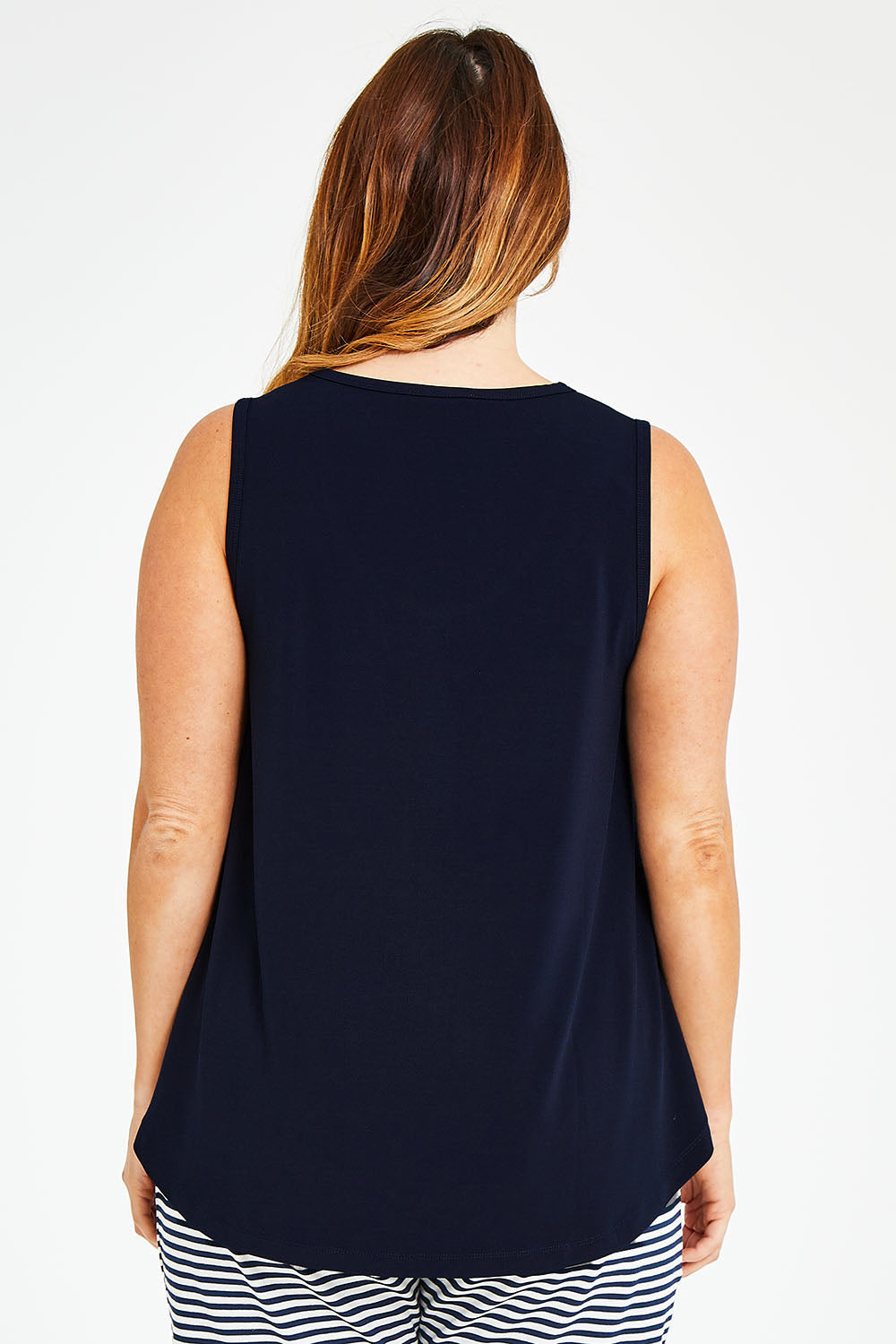 Model Laura wearing size 14 of The Essential Swing Tank in colour Navy (Blue), from the back