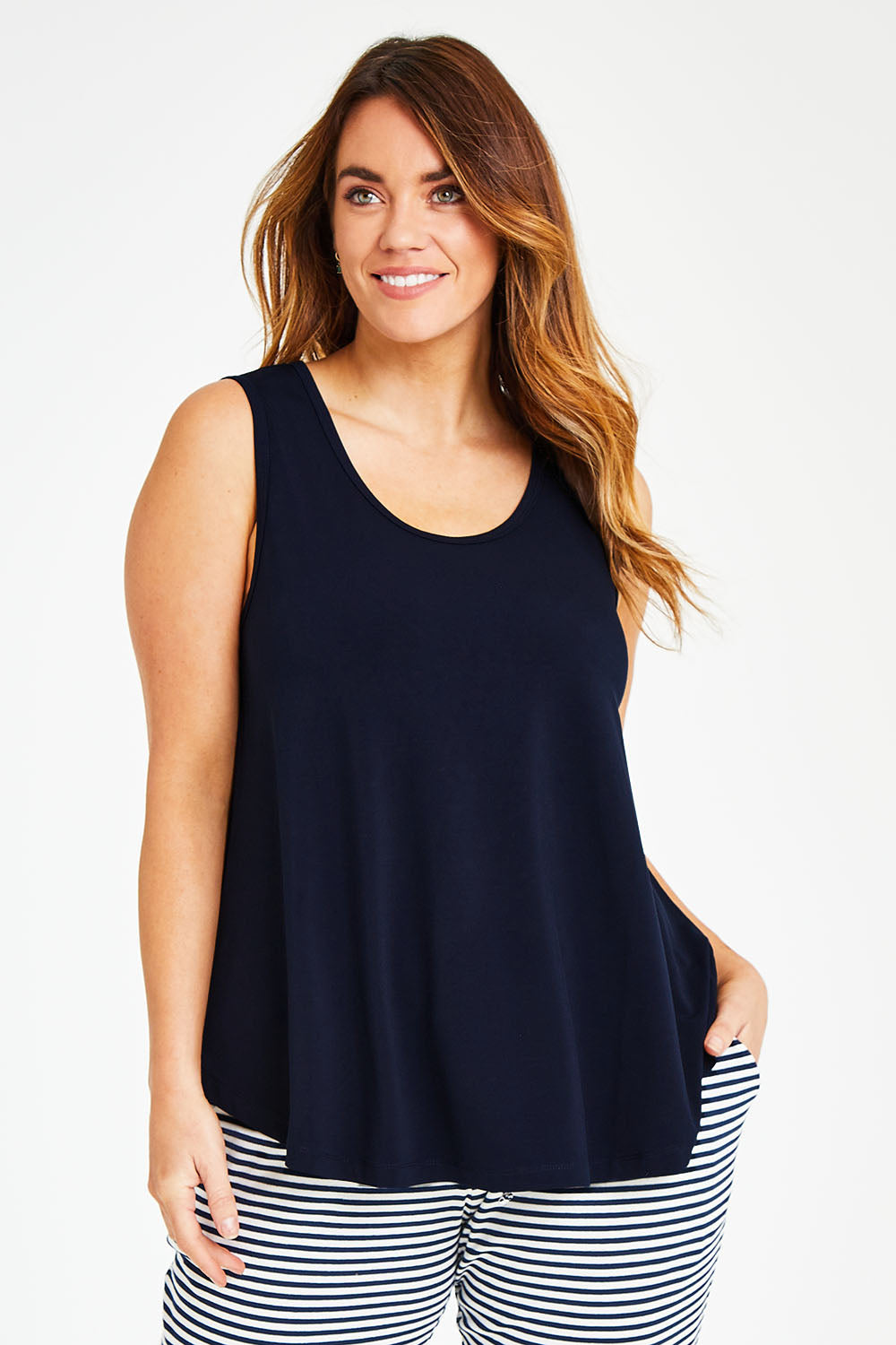 Model Laura wearing size 14 of The Essential Swing Tank in colour Navy (Blue), from the front, cropped image