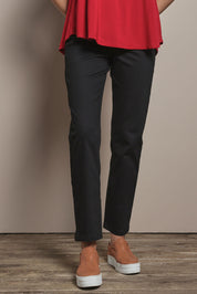 Model Madeline wearing size 10 of The 7/8 Pull On Pant in colour Black (Black), from the front, cropped image