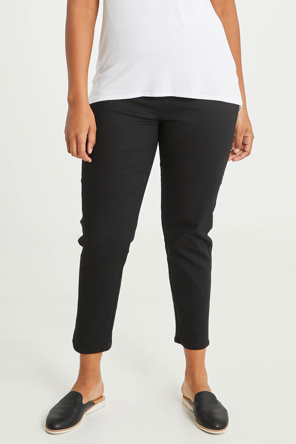 Model Noli wearing size 14 of The 7/8 Pull On Pant in colour Black (Black), from the front, cropped image