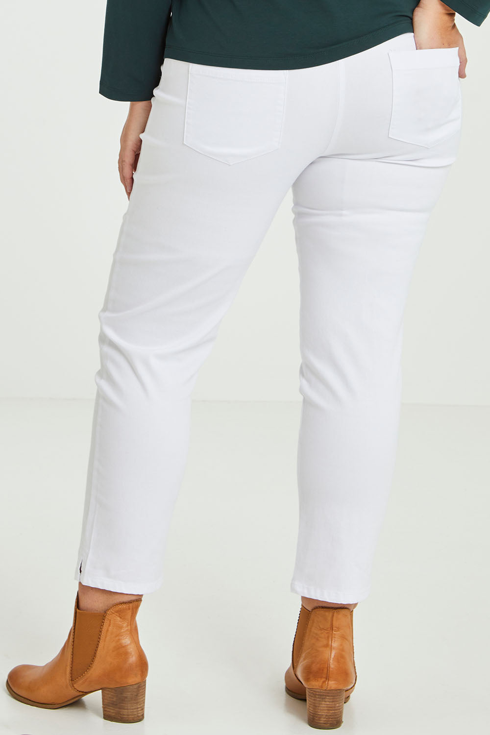 Model Fiona wearing size 16 of The 7/8 Pull On Pant in colour White (White), from the back