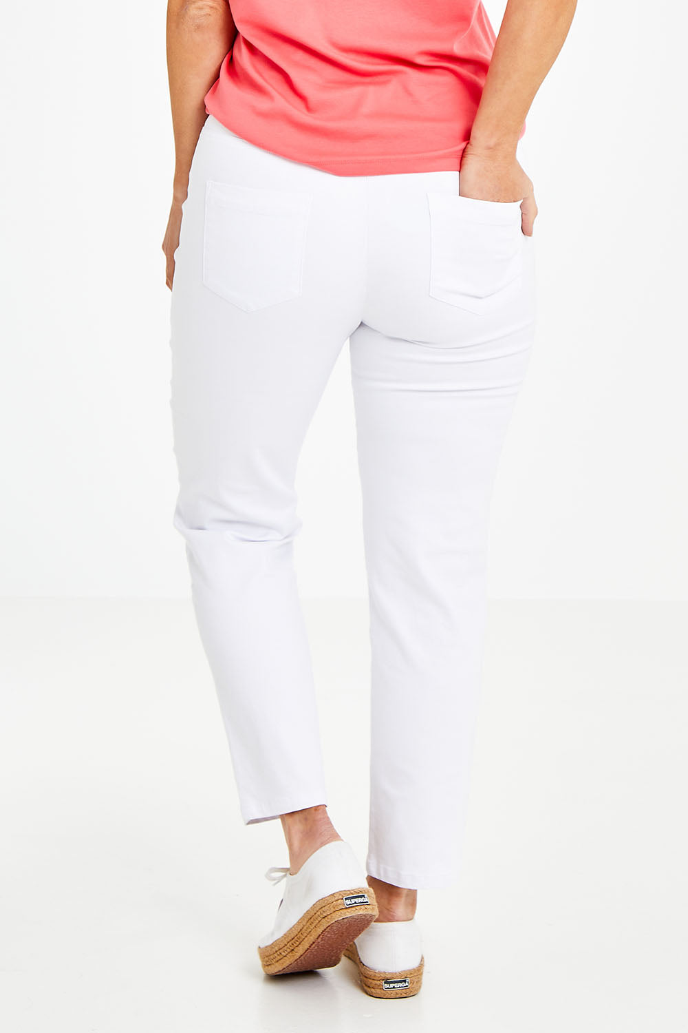 Model Laura wearing size 14 of The 7/8 Pull On Pant in colour White (White), from the front, cropped image