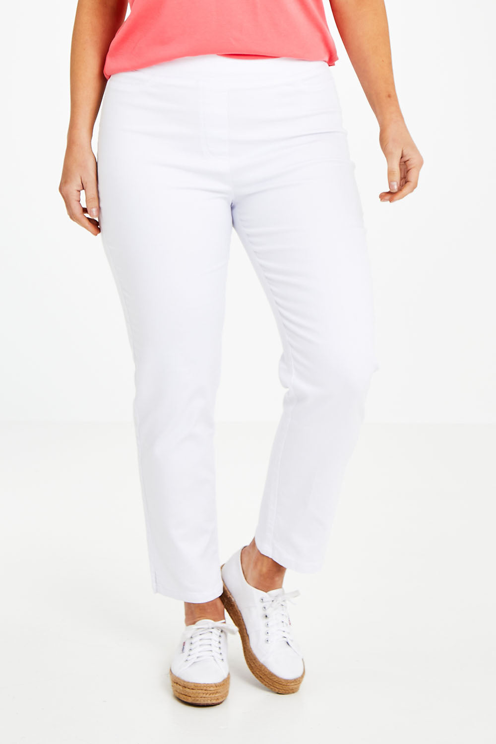 Model Laura wearing size 14 of The 7/8 Pull On Pant in colour White (White), from the front, cropped image