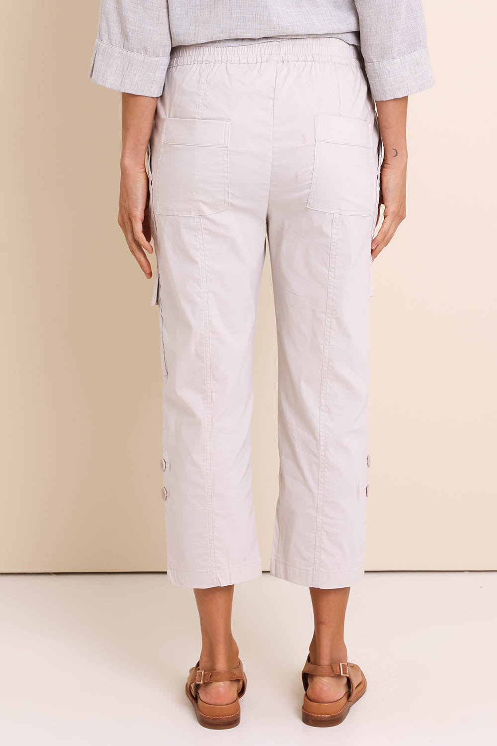 Model Amandam wearing size 10 of the The Lightweight Cotton Blend Cargo Pant – Pummice in colour Pummice, from the back