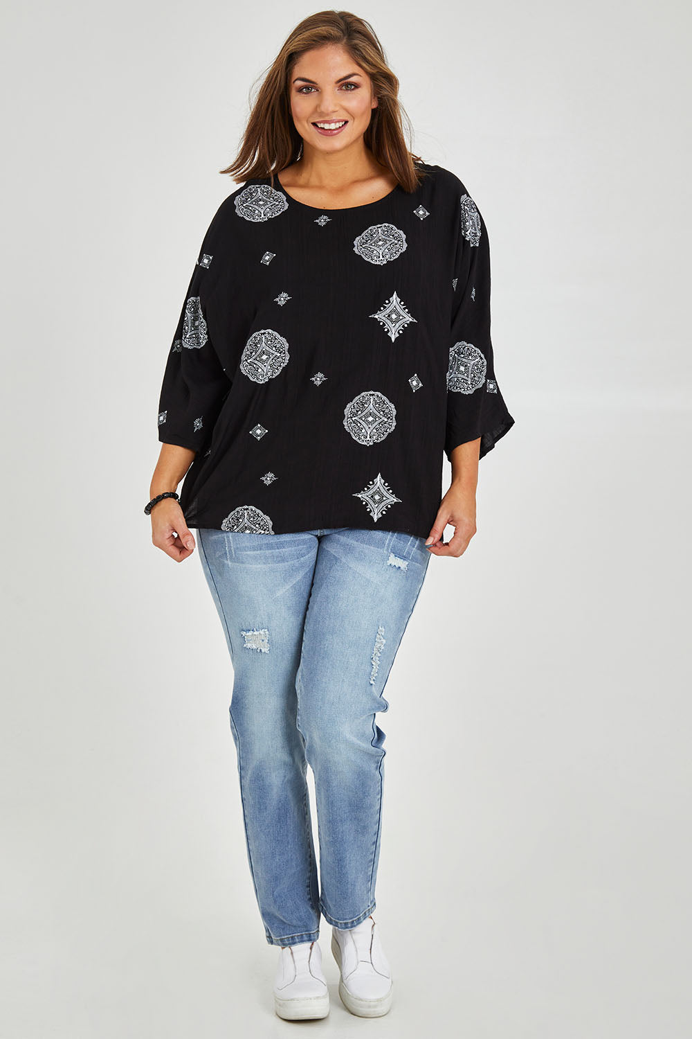 Model Monique wearing size 14 of The Relax Fit Printed Top in colour Blkfloral (Black), from the front, showing the whole outfit