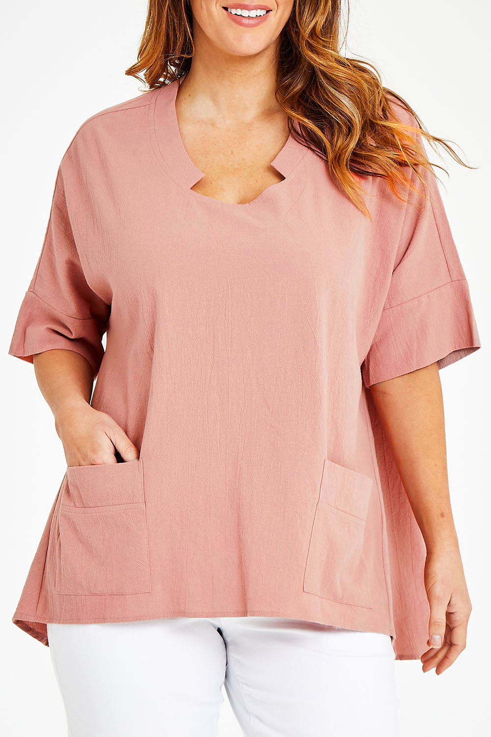 Model Laura wearing size 14 of The Upcycled Cotton Pocket Detail Top in colour Peach, from the front, cropped image