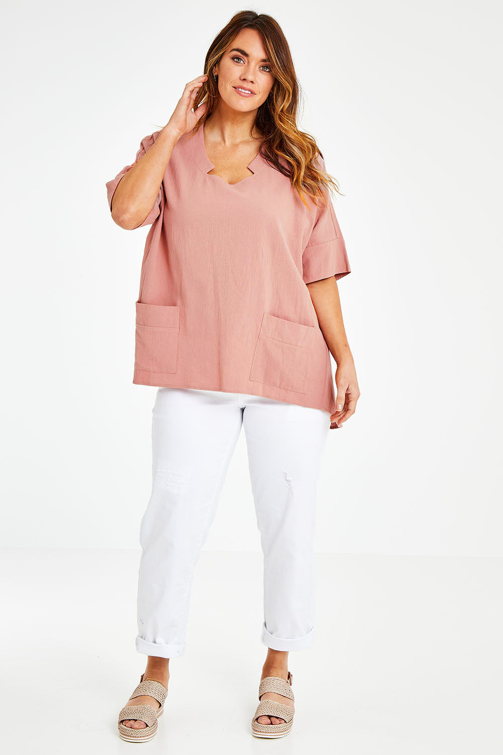 Model Laura wearing size 14 of The Upcycled Cotton Pocket Detail Top in colour Peach, from the front, showing the whole outfit