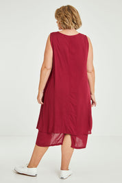 Model Fiona wearing size 16 of The Everyday Layered Dress in colour Cherryred (Red), from the back