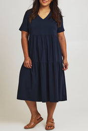 Model Ashleigh wearing size 16 of The Tiered Jersey Dress in colour Navy (Blue), from the front, cropped image