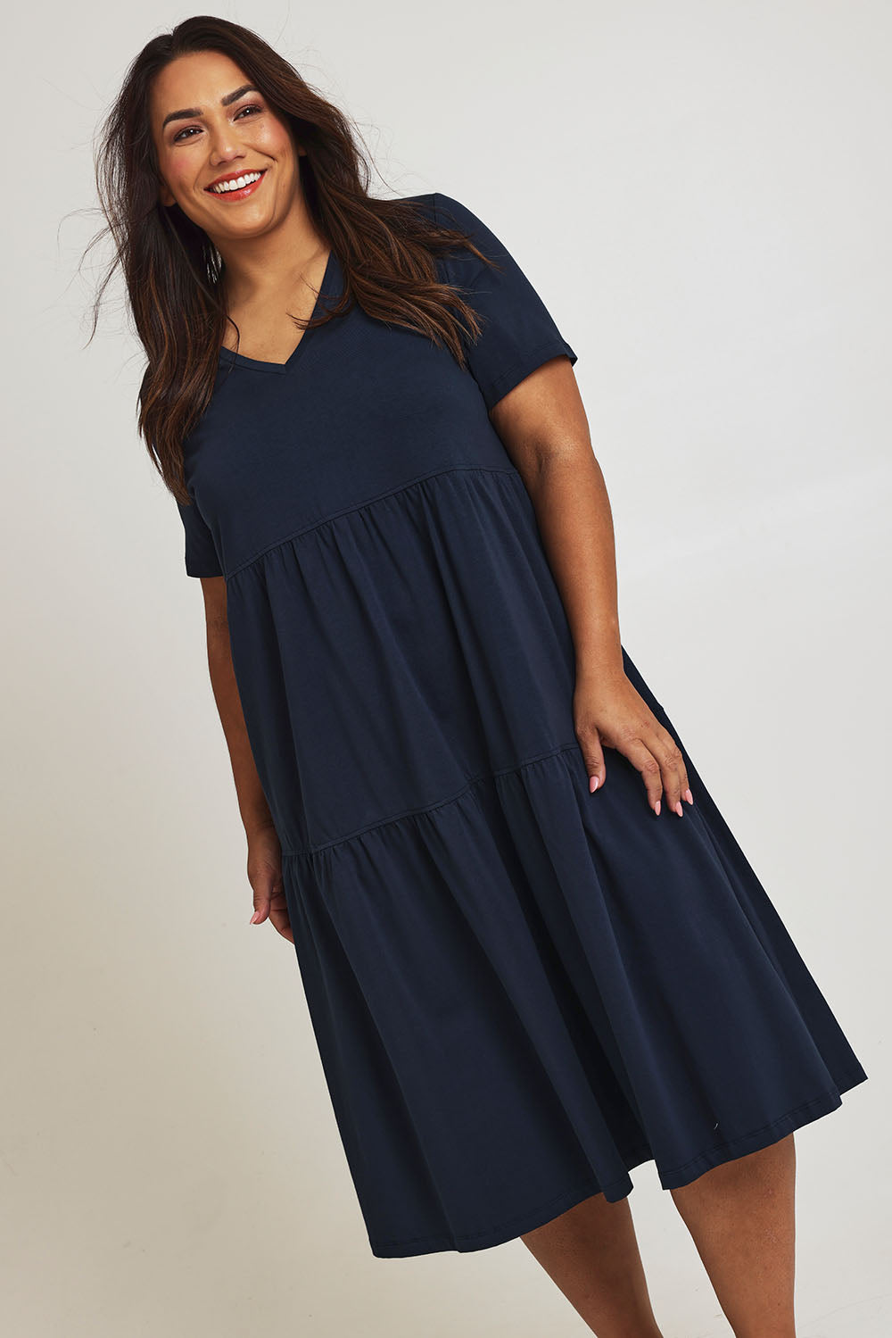 Model Ashleigh wearing size 16 of The Tiered Jersey Dress in colour Navy (Blue), from the front, cropped image