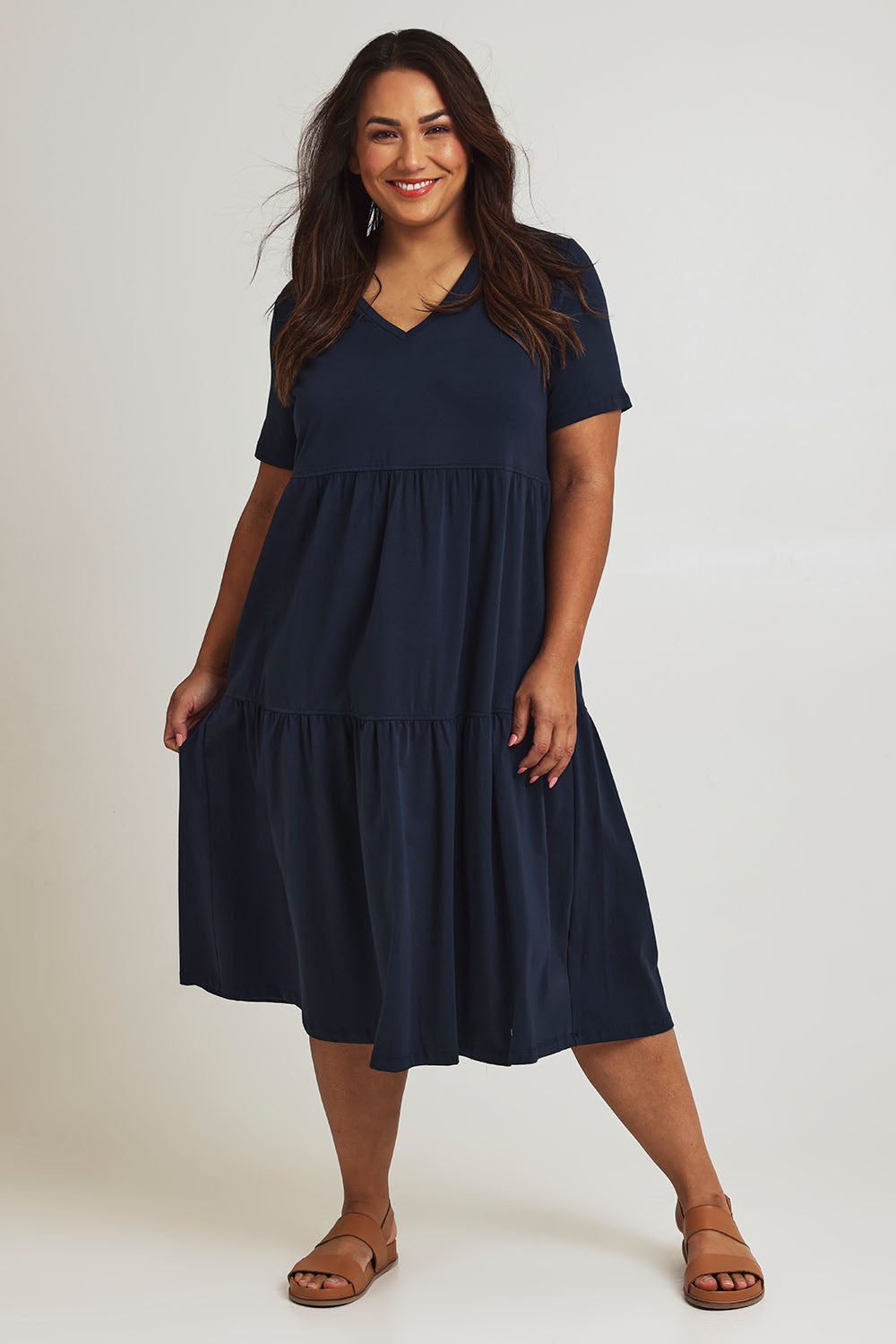 Model Ashleigh wearing size 16 of The Tiered Jersey Dress in colour Navy (Blue), from the front, showing the whole outfit