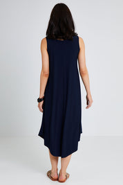 Model Andrea wearing size 10 of The Recycled High Low Dress in colour Navy (Blue), from the back