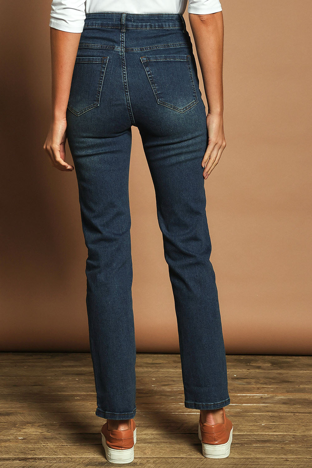 Model Madeline wearing size 10 of The Keepers Highwaisted Straight Jean in colour Darkdenim (Blue), from the back