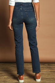 Model Madeline wearing size 10 of The Keepers Highwaisted Straight Jean in colour Darkdenim (Blue), from the back