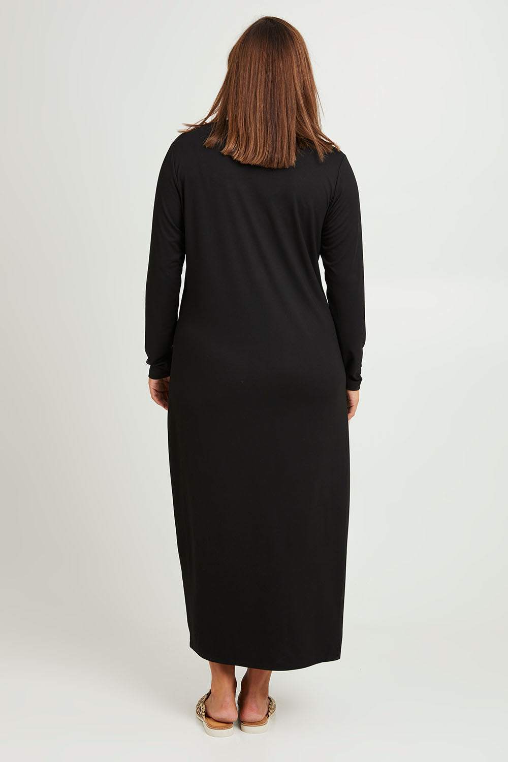 Model Monique wearing size 14 of The Long Sleeve Bamboo Dress in colour Black (Black), from the back