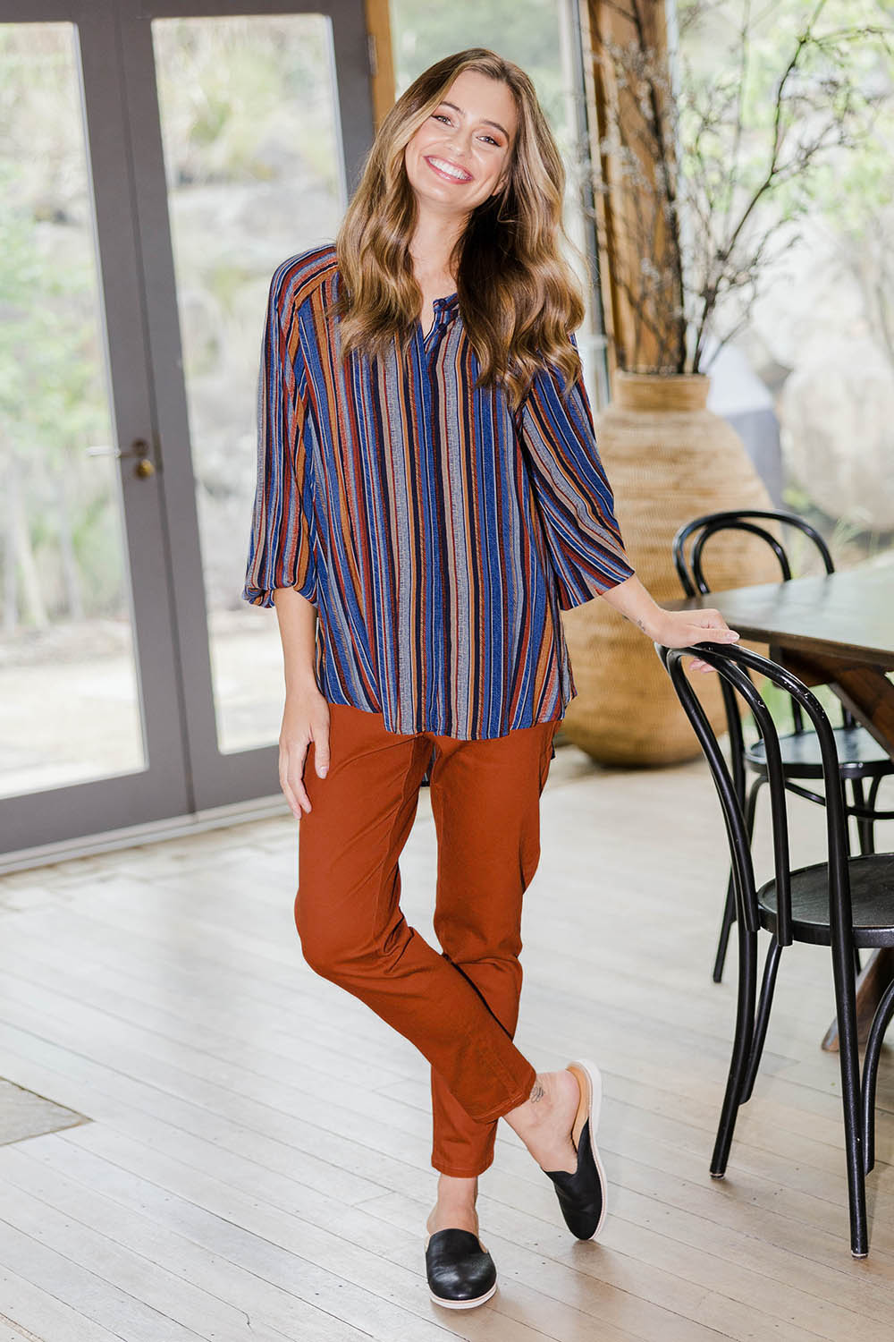 Model Tahlia wearing size 10 of The Long Sleeve Crew Neck Shirt in colour Camelstrip (Blue), from the front, showing the whole outfit